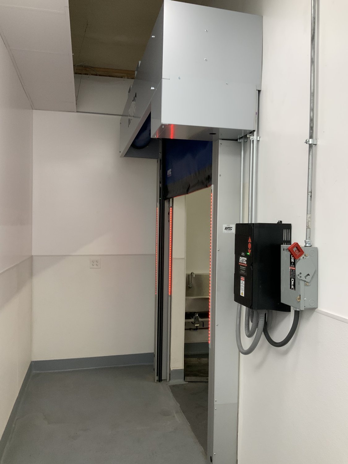 High-speed door control equipment and operator components inside an industrial facility