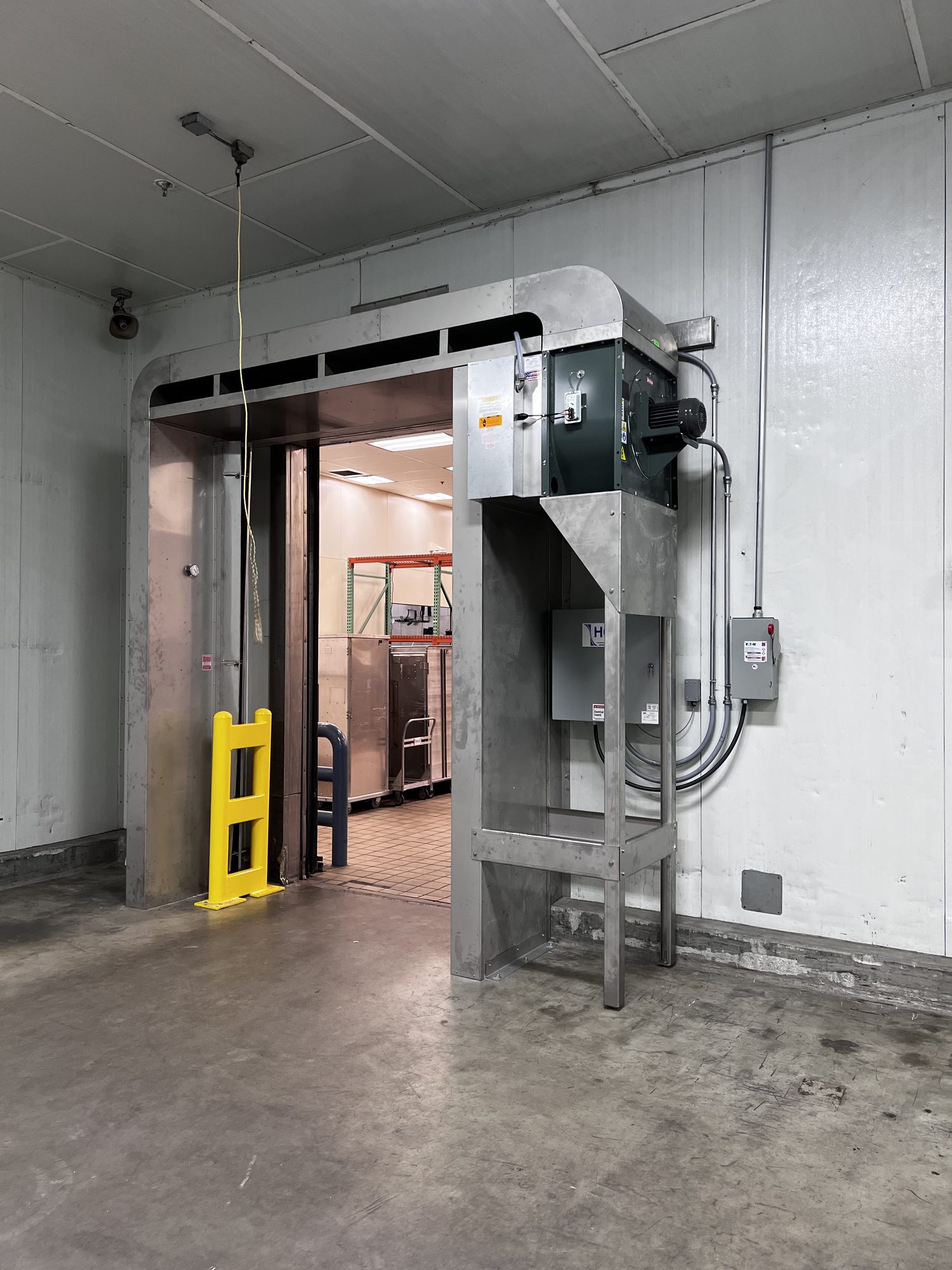 Industrial door equipment and protective bollards inside a facility