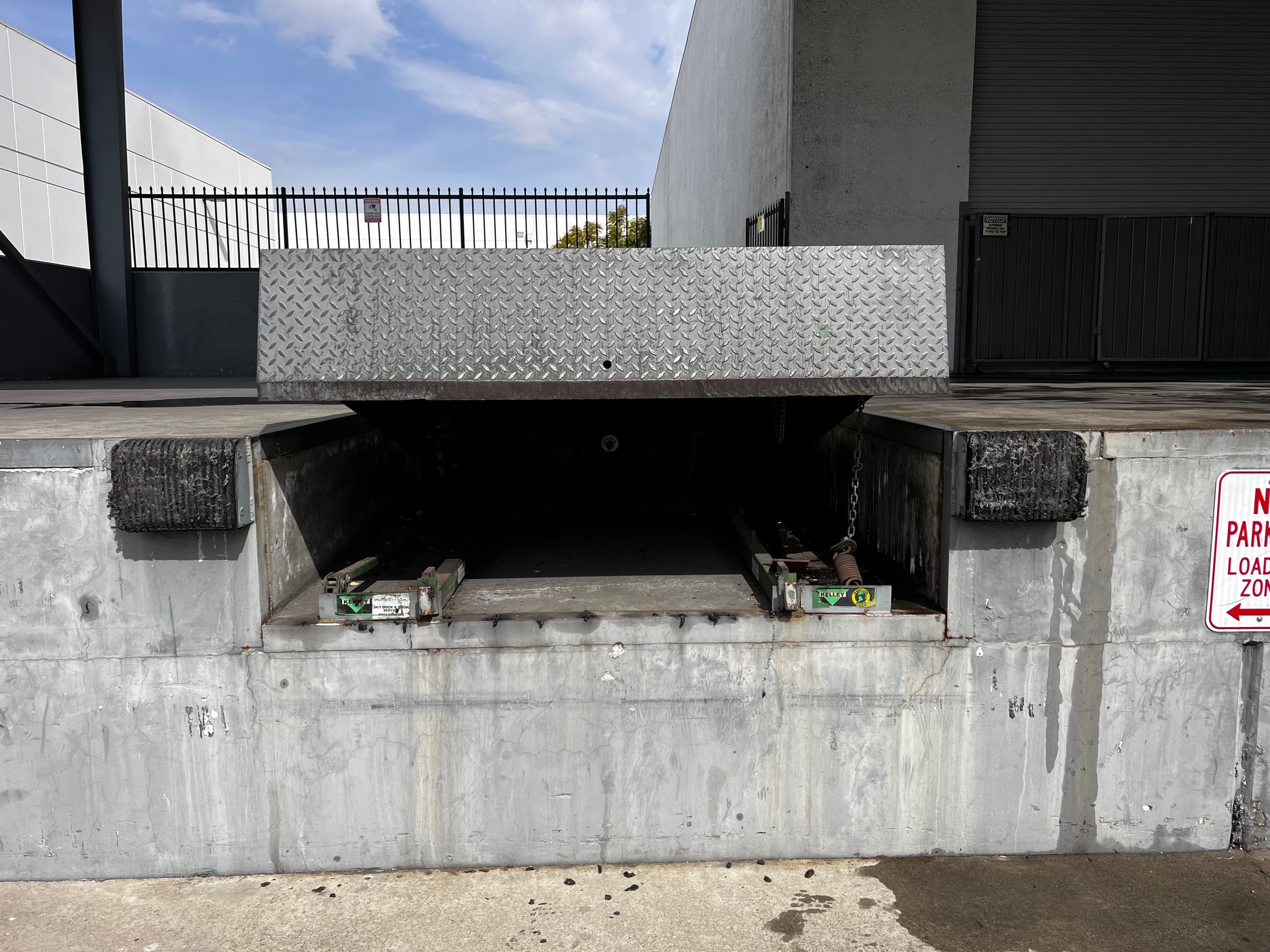 Raised dock leveler showing the loading dock pit and operating components